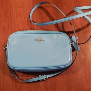 Small Coach crossbody bag.